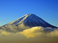 頭を雲の上に出す富士山
